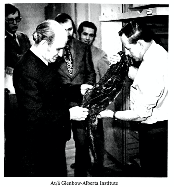Gerard Pelletier looking at an artifact