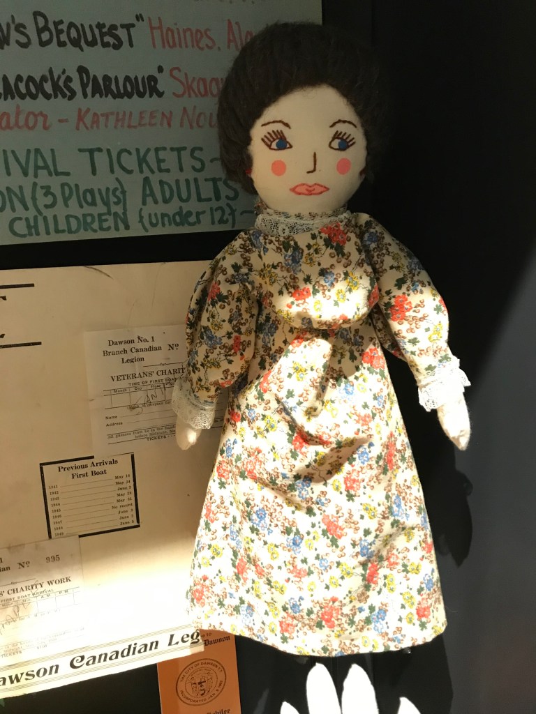 A close up of a doll in a display on celebrations at the Dawson City Museum,