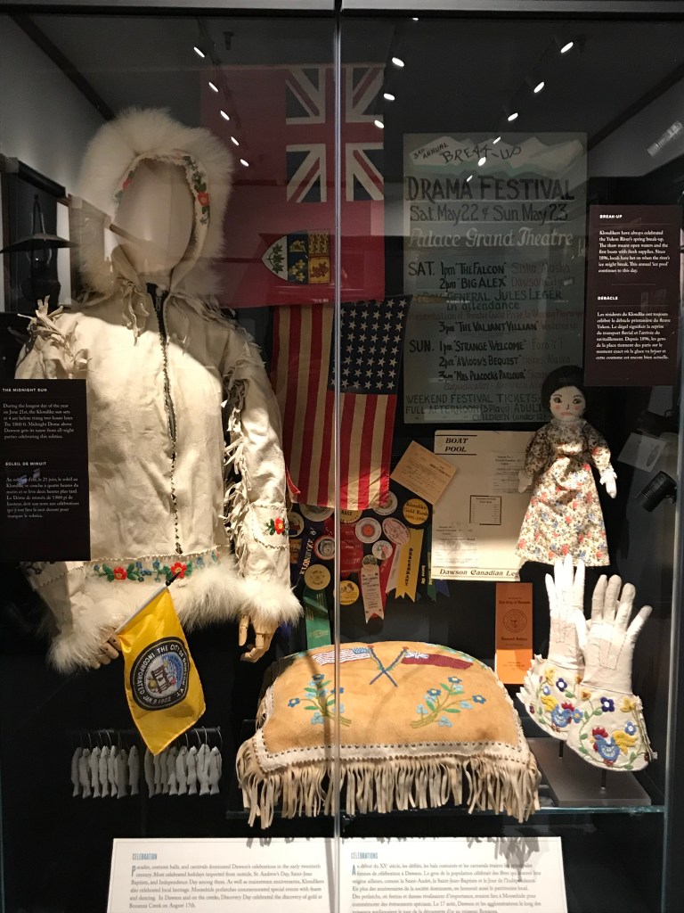A color photo of a display on celebrations at the Dawson City Museum. 
